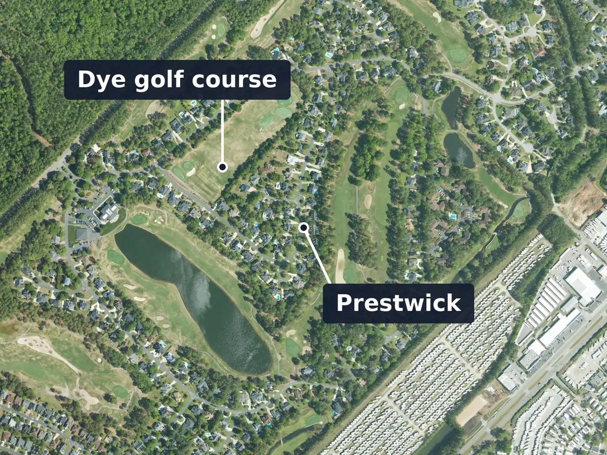 Prestwick from above, labelled: houses among the fairways of a golf course, with a long lake at the left; labels: Dye golf course and Prestwick